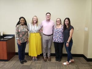 Group of staff members posing for photo.