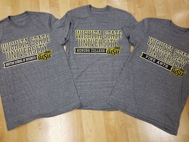 Tshirts with text (Wichita State University Honors College, Wichita State University Fine Arts, Wichita State University Barton School of Business).