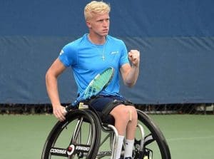 Pictured Casey Ratzlaff playing tennis on the court.