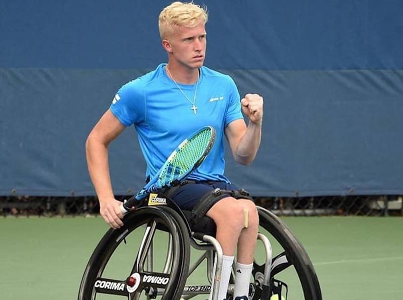 Pictured Casey Ratzlaff playing tennis on the court.