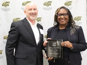 Alicia Thompson holding a plaque she received at the ceremony