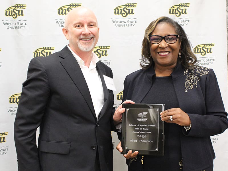 Alicia Thompson holding a plaque she received at the ceremony