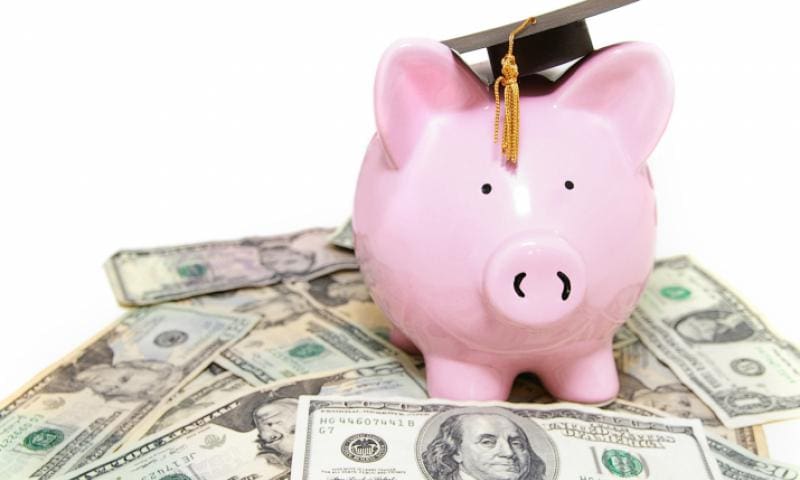 Piggy bank wearing graduation cap.