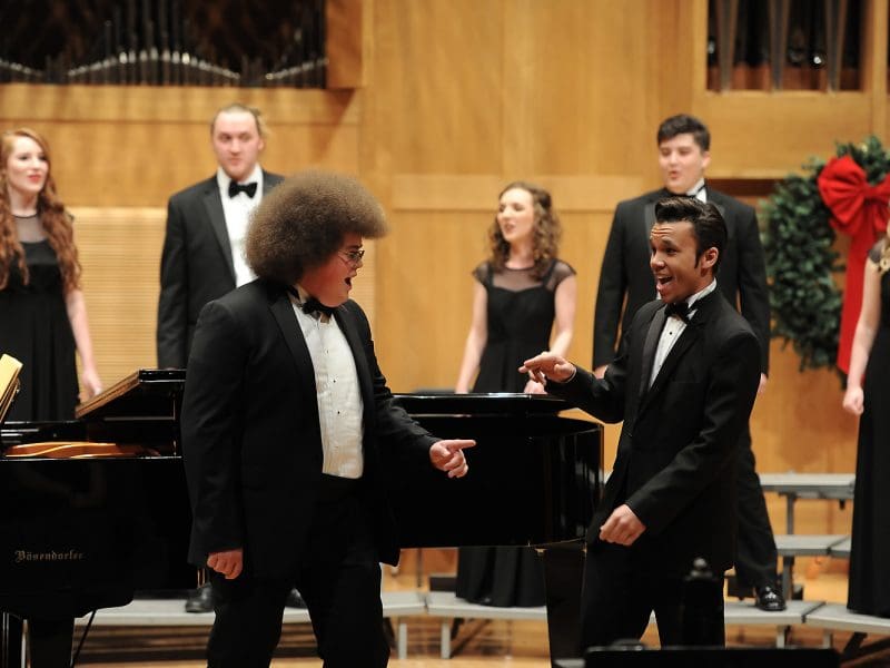 Two members of the madrigal singers perform in a past candlelight concert.