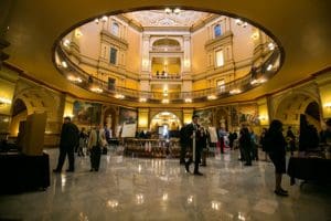 Students presenting research posters in the State Capitol rotunda in Topeka.