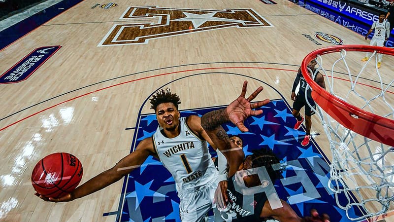 Picture of Wichita State Basketball player making a dunk into a basketball hoop.