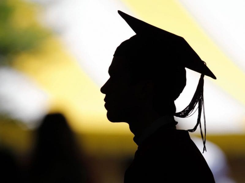 A headshot of a college graduate in silhouette.
