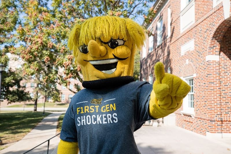 WU supporting First-Gen Shockers. WU wearing a first-gen Shockers t-shirt.