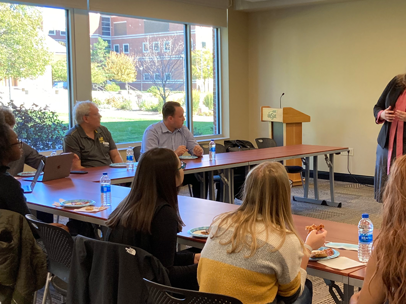 Abigail Devereaux presents a paper to students during an ISEG mentoring group meeting.