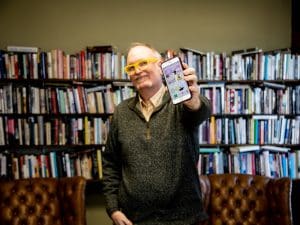 Darren DeFrain, associate professor of English at Wichita State University, shows off a page of the Vizling app, which will allow users to understand reading materials that rely on visual components to help tell a story or communicate information.