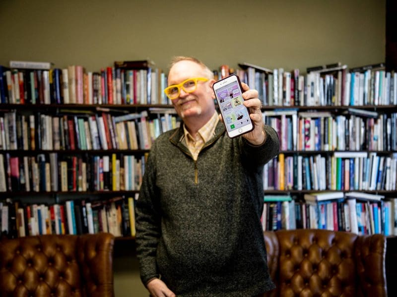 Darren DeFrain, associate professor of English at Wichita State University, shows off a page of the Vizling app, which will allow users to understand reading materials that rely on visual components to help tell a story or communicate information.