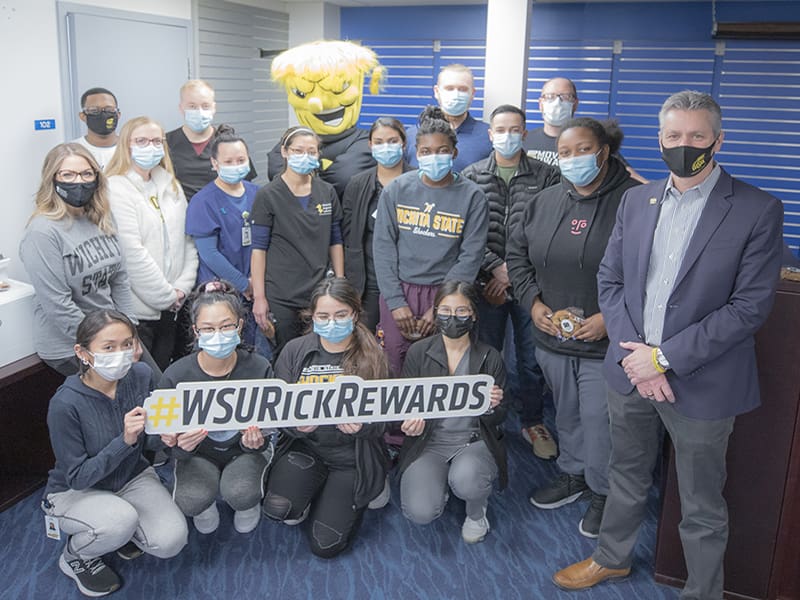 The members of the Molecular Diagnostics Lab are pictured with Wu and President Rick Muma.