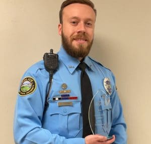 Uniformed Wichita State University Police Officer Dorion holding the Dottie C. Miller Award
