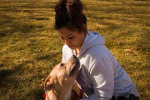 Picture of dog being hugged by female student.