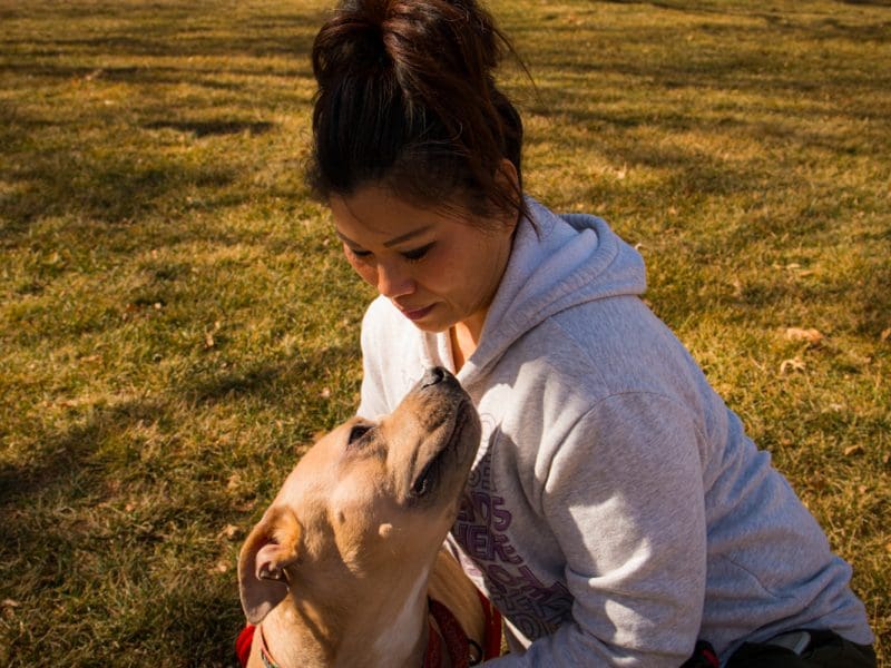 Picture of dog being hugged by female student.