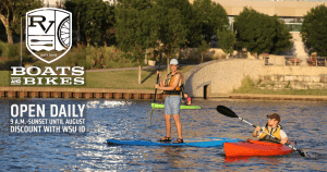 Image of man and woman kayaking on river and