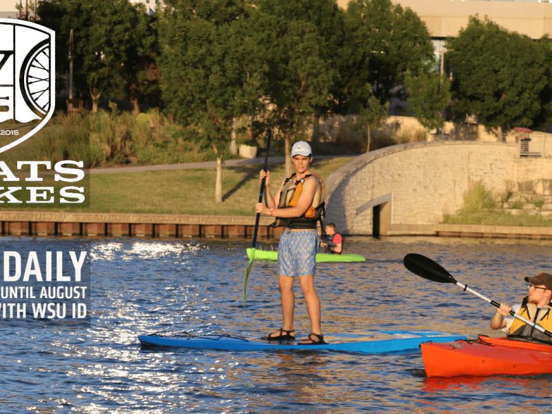 Image of man and woman kayaking on river and