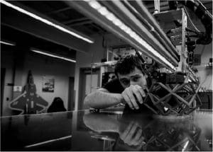 Student using robot to 3D print part.