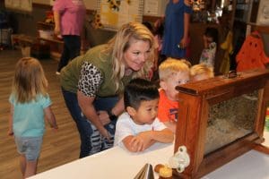 Photo of teacher and young children playing at WSU's CDC.