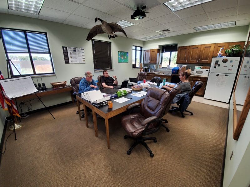 Two WSU Environmental Finance Center staff are shown discussing asset management with staff from the El Dorado wastewater treatment plant.
