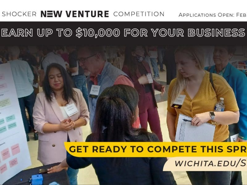 People meandering between competitor booths at the SNVC Trade Show. "Shocker New Venture Competition. Applications Open: February 27th. Earn up to $10,000 for your business idea. Get ready to compete this spring!"