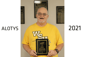 Billy Wilson, the 2021 Adult Learner of the Year winner, holds his award plaque.