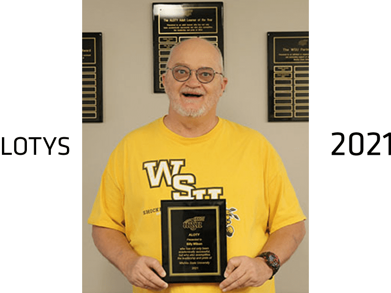 Billy Wilson, the 2021 Adult Learner of the Year winner, holds his award plaque.