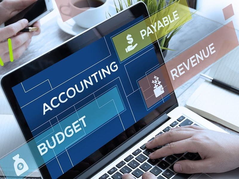 Image of laptop with the words Budget, Accounting, Payable, and Revenue listed.