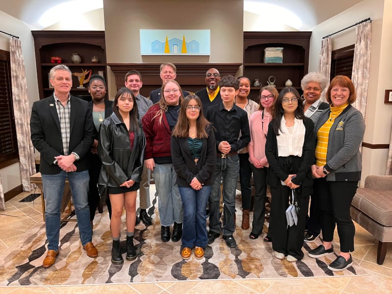 Photo of TRIO Upward Bound Math Science students being recognized by President Muma at dinner at the President's Residence.