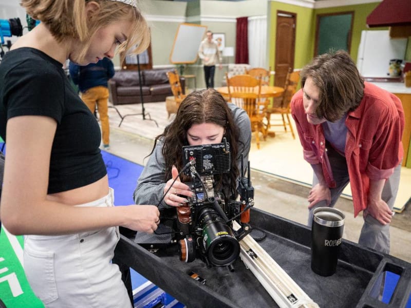 Photo of students working on the new sit-com set at Shocker Studios.