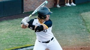 Photo of Carline Tallent getting ready to bat at a softball game.