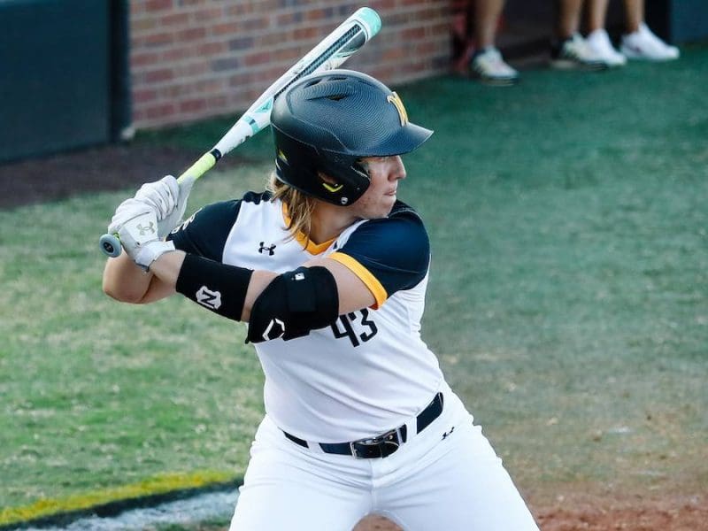 Photo of Carline Tallent getting ready to bat at a softball game.