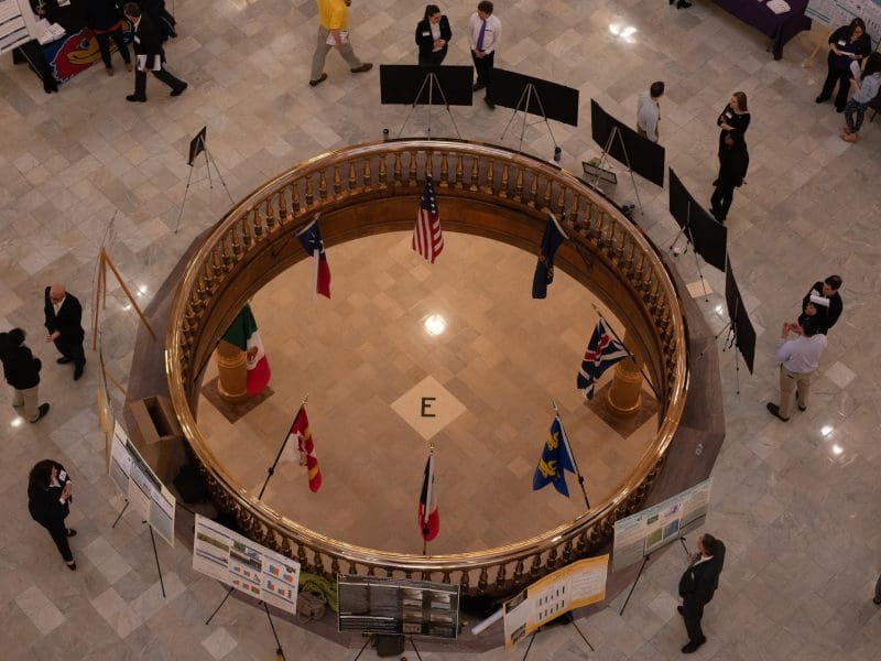 Photo of graduate students presenting their research at the Capitol Rotunda.