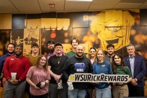 A photo of the Student Government Association with President Rick Muma holding up the Rick Rewards sign.