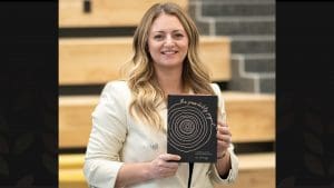 Photo of Erin Cummings with her new book in Woolsey Hall.