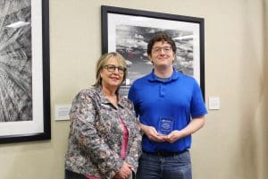 Photo of Teri Hall and Colton Ediger standing with divisional award.