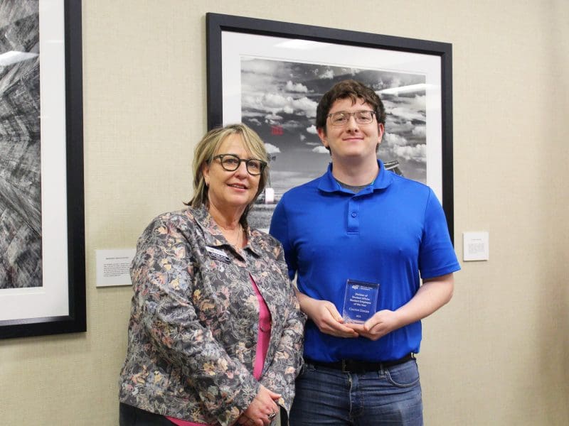 Photo of Teri Hall and Colton Ediger standing with divisional award.