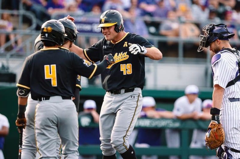 Photo of Shocker baseball players celebrating during the game against Kansas State University.
