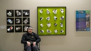 Photo of Nick Wooding in front of the Envision art installation in Woolsey Hall.