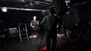 An actor reads a script for a director in a recording studio.