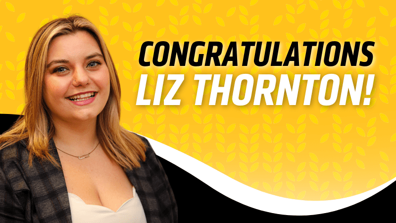Yellow background with light yellow wheat pattern. Liz Thornton photo on left side with "Congratulation Liz Thornton!" on right side. Black and white border on bottom of image.
