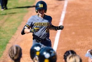 Photo of Sydney McKinney running the bases in a softball game.