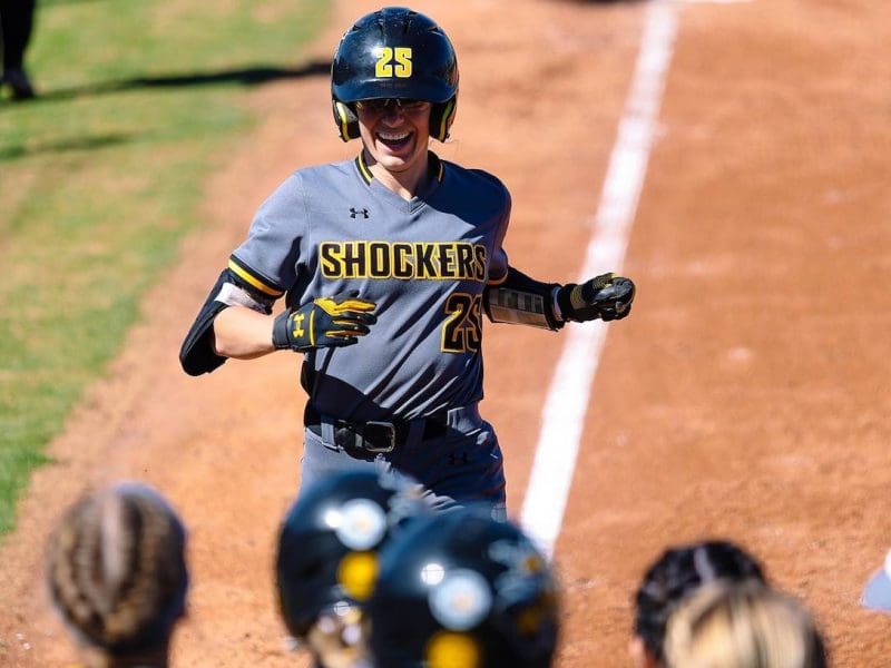 Photo of Sydney McKinney running the bases in a softball game.