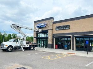 Maintenance workers put up the Jersey Mike's sign at Braeburn Square