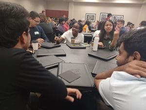 Group of students chatting at an event.