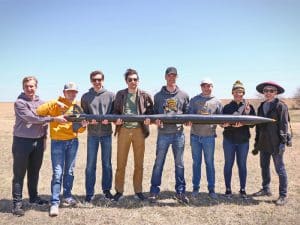 Members of the WSU Rocket Club pose with one of their rockets
