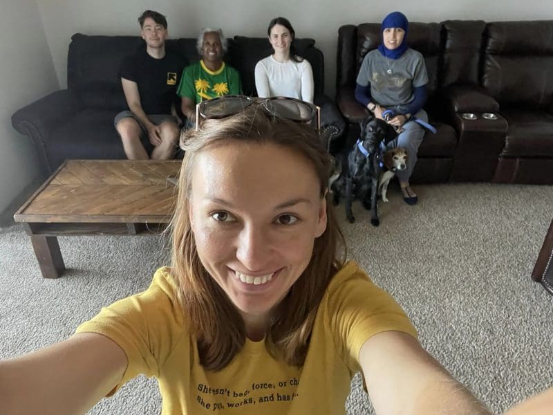 A volunteer takes a selfie with Wichita-based refugees from other countries.
