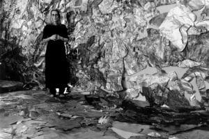 Artist Lesley Dill stands in front of a metallic background in this photo by George Woodman.