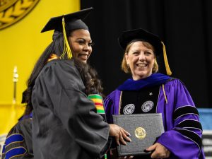 Provost Shirley Lefever hands a Shocker their diploma