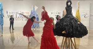 Dancers perform among works of art in a gallery.